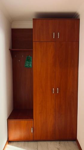 a large wooden cabinet in a room at Bianco - pokoje noclegowe in Częstochowa