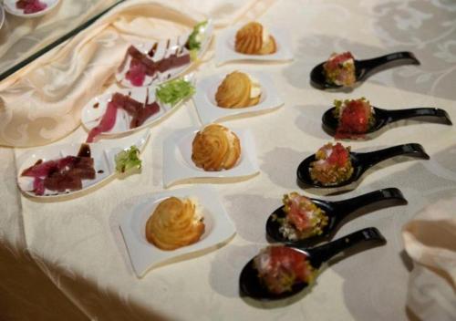 a table with many plates of food on it at Grand Hotel Stella Maris Italia in Palmi