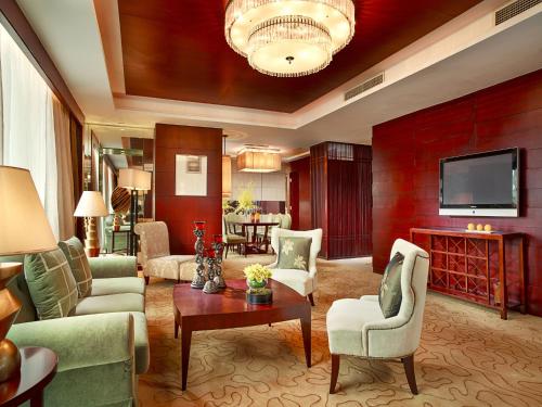 a living room filled with furniture and a flat screen tv at Sofitel Nanjing Galaxy in Nanjing