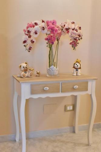a table with a vase of flowers on it at Bed and Breakfast Il Girasole in Mondello