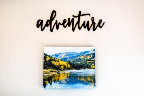 a sign that reads adventure with a picture of a lake at Garden of the Gods RV Resort in Colorado Springs