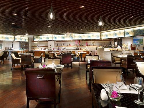 a dining room with tables and chairs and a restaurant at Sofitel Nanjing Galaxy in Nanjing