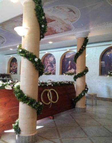a room with two columns with christmas decorations on them at Grand Hotel Stella Maris Italia in Palmi