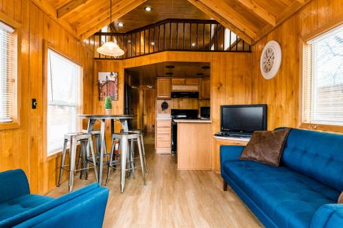 a living room with a blue couch and a kitchen at Garden of the Gods RV Resort in Colorado Springs