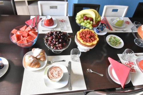 a table topped with plates of food and fruit at Bed and Breakfast Il Girasole in Mondello