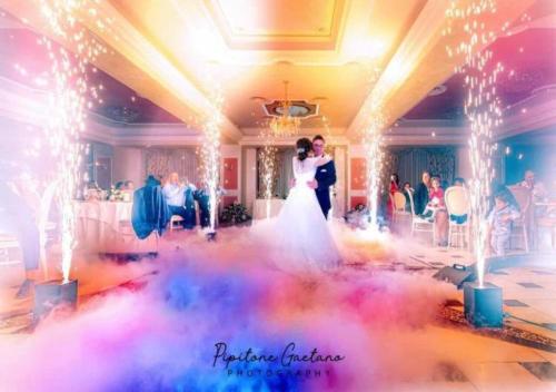 a bride and groom dancing in a room with lights at Grand Hotel Stella Maris Italia in Palmi