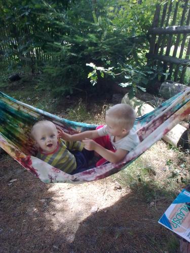 two babies are sitting in a hammock at chata FRIDAY in Ktová