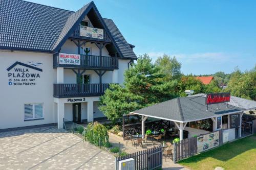 a building with a patio in front of it at Willa Plażowa in Mielenko