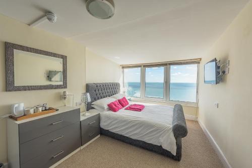 a bedroom with a bed with a sink and a window at Villa Mentone Hotel in Shanklin