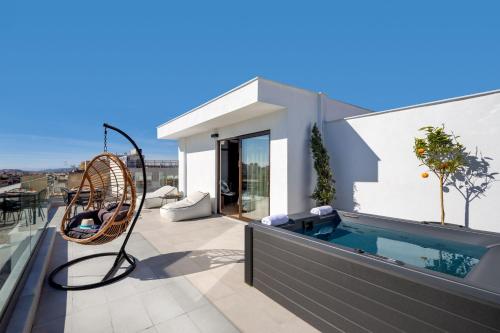 a house with a swimming pool on a roof at Filopappou Hill Suites by Athens Stay in Athens