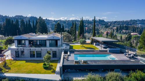 an aerial view of a house with a swimming pool at Villa BLUELINE in Alykes Potamou