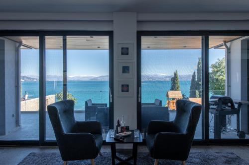 a living room with a view of the ocean at Villa BLUELINE in Alykes Potamou