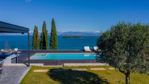 a swimming pool with a view of the water at Villa BLUELINE in Alykes Potamou