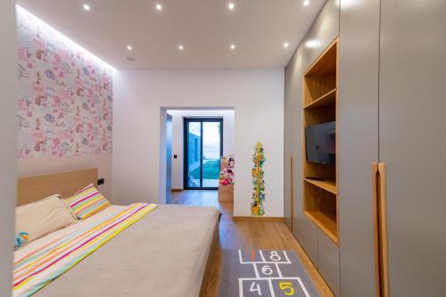 a small bedroom with a bed and a tv at Villa BLUELINE in Alykes Potamou