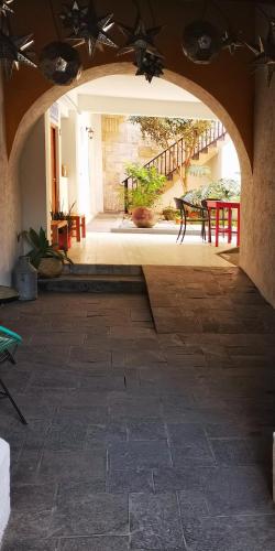an archway in a room with a table and benches at Santa Josefita B&B in Cholula