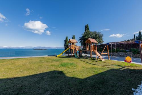 a park with a playground with a slide at Villa BLUELINE in Alykes Potamou