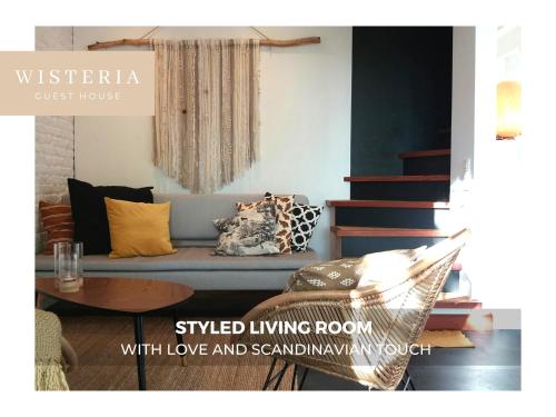a living room with a couch and a table at Wisteria Guest House in Villers-lʼÉvêque