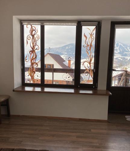 a room with a window with a view of a mountain at AGORA Chalet in Slavske