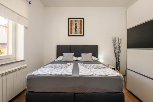 a bedroom with a large bed in a room at Villa Vanja - Jadreški in Pula