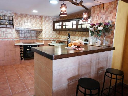 a kitchen with a counter with some food on it at La Roca de Setenil in Setenil