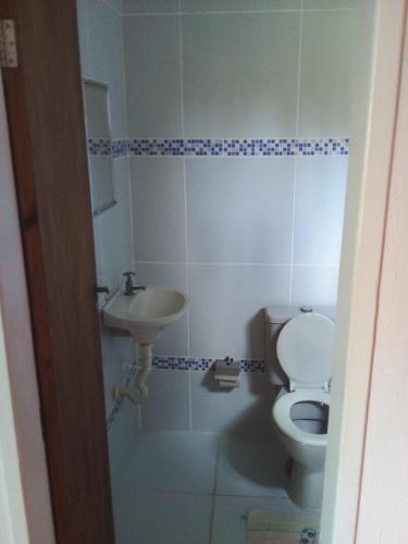 a bathroom with a toilet and a sink at Pousada Portuguesa in Natal