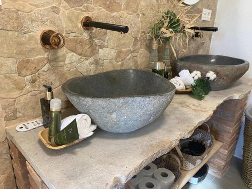 a bathroom with a large bowl sink on a counter at Finca Las Fuentezuelas in Carataunas