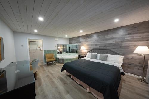 a bedroom with a large bed and a bathroom at Choice Inn by the falls in Niagara Falls