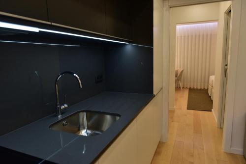 a kitchen with a sink and a counter top at The Castle House in Lamego
