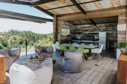 an outdoor living room with a table and chairs at Oakridge Glamping in Rotorua