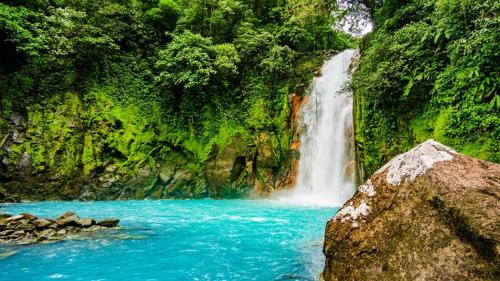 a waterfall in the middle of a river at Agutipaca Bungalows in Bagaces
