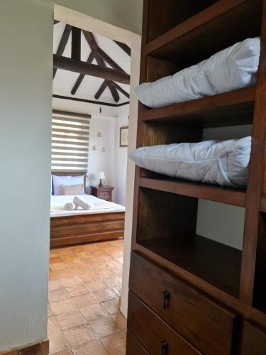 a room with a bedroom with a bed and bunk beds at Casa Campestre San Jorge in Villa de Leyva