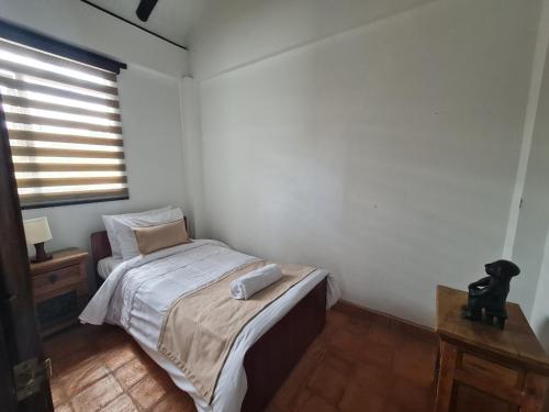 a small bedroom with a bed and a window at Casa Campestre San Jorge in Villa de Leyva