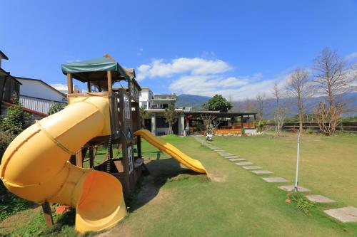 a playground with a slide in a park at Jiang's B&B 江院子庭園民宿 in Jian