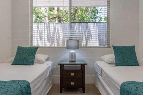 Ένα ή περισσότερα κρεβάτια σε δωμάτιο στο Lychee Tree Holiday Apartments