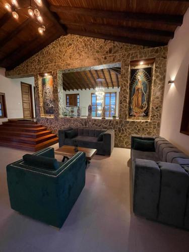 a living room with couches and a stone wall at San Miguel de Montenegro in Montenegro