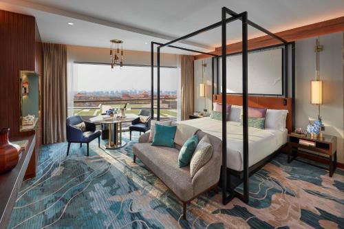 a bedroom with a bed and a living room at Mandarin Oriental Wangfujing, Beijing in Beijing