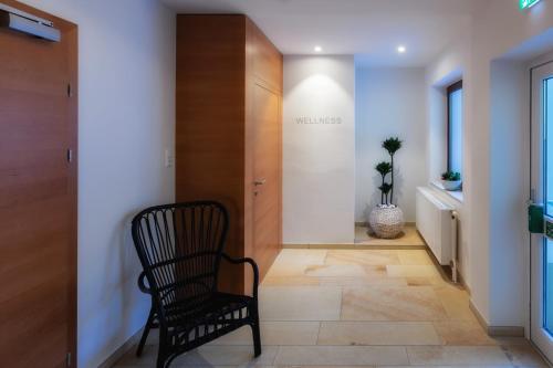 a hallway with a chair in front of a door at Belvedere in Semmering
