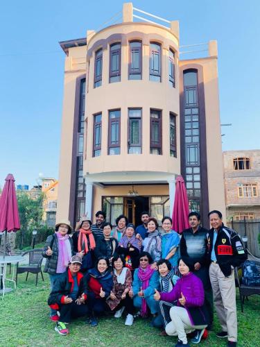 a group of people posing in front of a building at The Shelter Heritage A Boutique Hotel in Srinagar