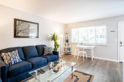 a living room with a blue couch and a table at Luxury stay near Oakridge Mall for vacation/work in San Jose