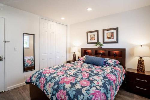 a bedroom with a bed with a floral bedspread at Luxury stay near Oakridge Mall for vacation/work in San Jose