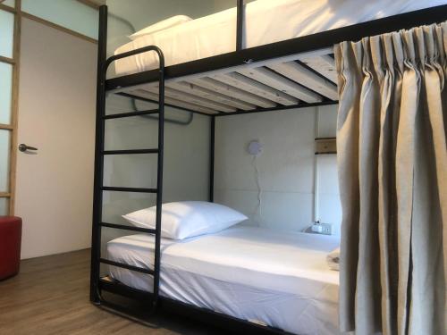 台南的住宿－Simple Walk Guest House 小公寓，卧室配有2张双层床和白色床单