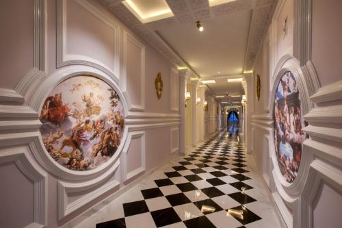 a hallway with paintings on the walls and a checkered floor at arte by Thomas Chan in Kuala Lumpur