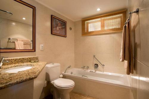 a bathroom with a toilet and a sink and a tub at Bakubung Self-Catering Apartment by Top Destinations Rentals in Ledig