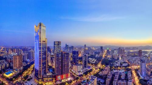 a view of a large city at night at Pullman Huizhou Kaisa in Huizhou