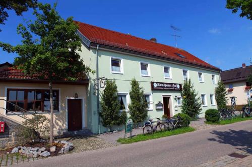 a large white building with a red roof at Ramspauer Hof in Regenstauf