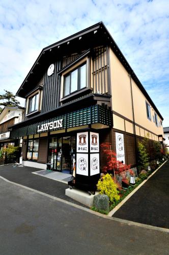 a black and white building with a store at Oyado Yukizumi in Kusatsu