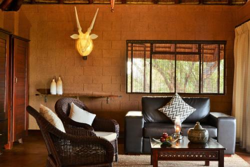 a living room with a couch and a table at Zwahili Private Game Lodge & Spa in Modimolle