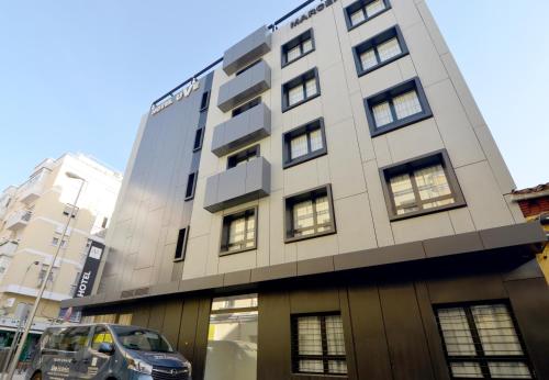 a building with a car parked in front of it at UVE Marcenado in Madrid