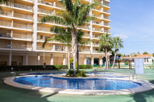 a swimming pool in front of a large apartment building at Ambar Beach Morpar Calp in Calpe