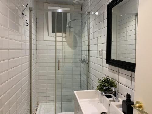a bathroom with a sink and a glass shower at Coimpact Coliving Bruc in Barcelona